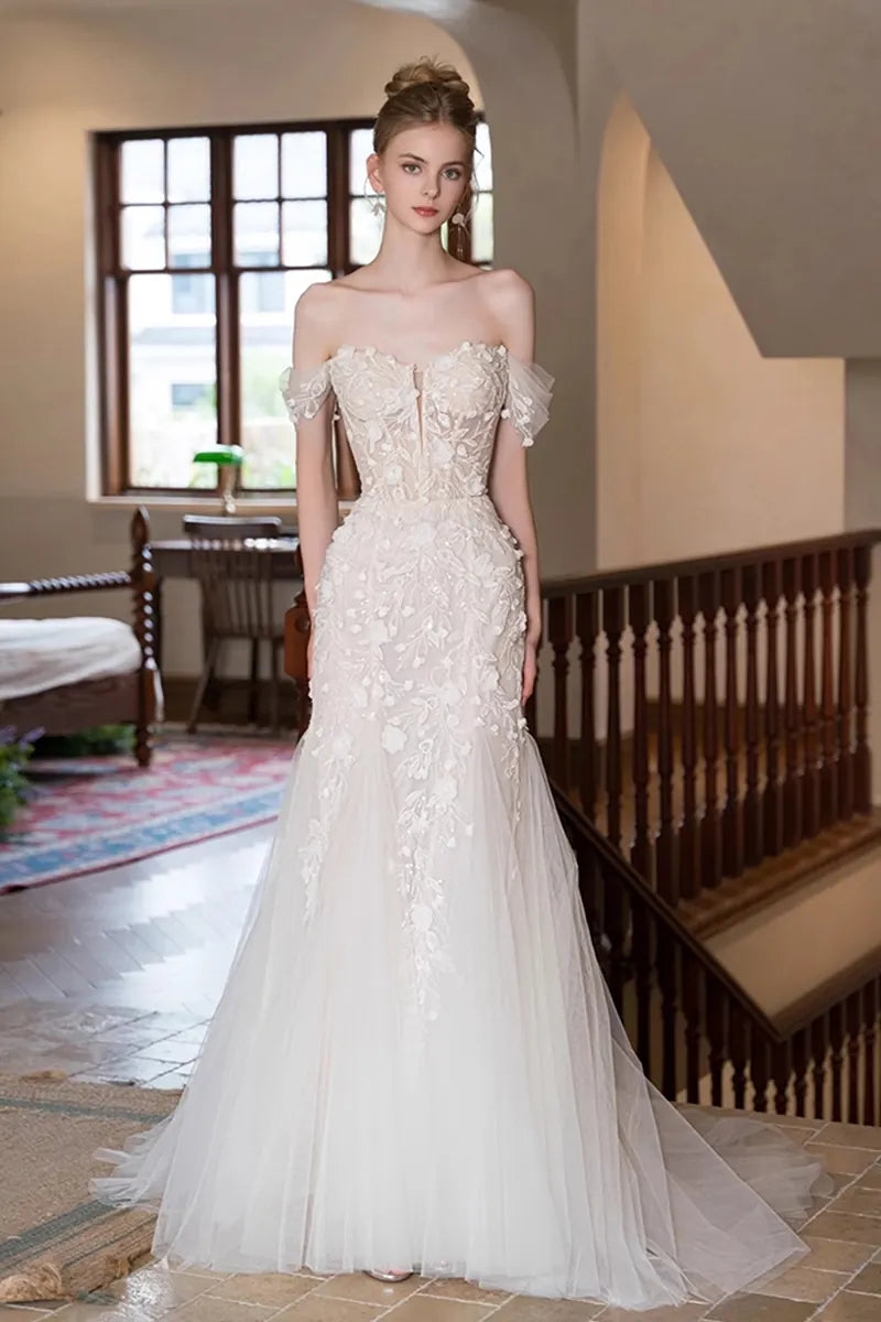 Bohemian mermaid wedding dress with a boat neck and lace trim with a semi-open back - creating a balanced silhouette