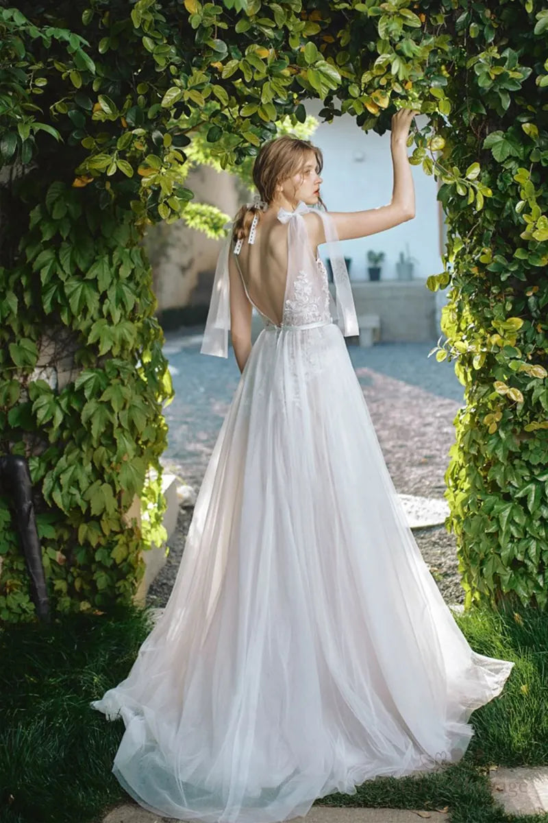 Robe de mariée bohème sur-mesure avec dos nu et dentelle fine, dans un jardin verdoyant
