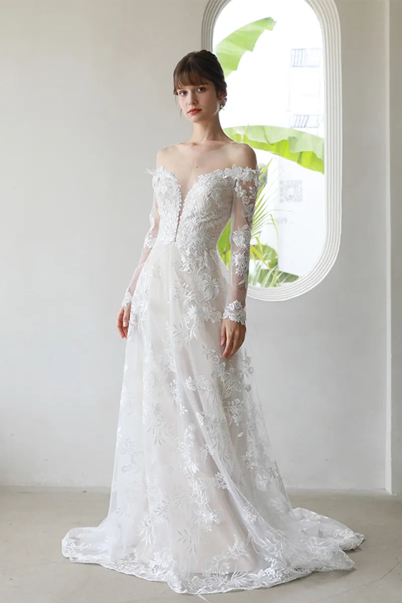 Romantic bohemian wedding dress with long lace sleeves and a boat neckline - sophisticated, timeless elegance