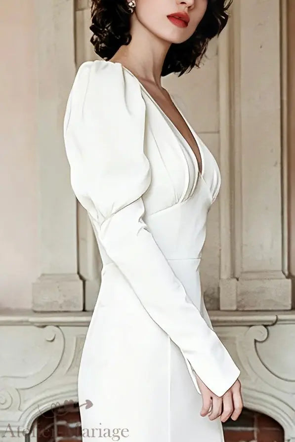 Détail de la manche bouffante en satin d'une robe de mariée vintage, illustrant le volume couture et le drapé soyeux.