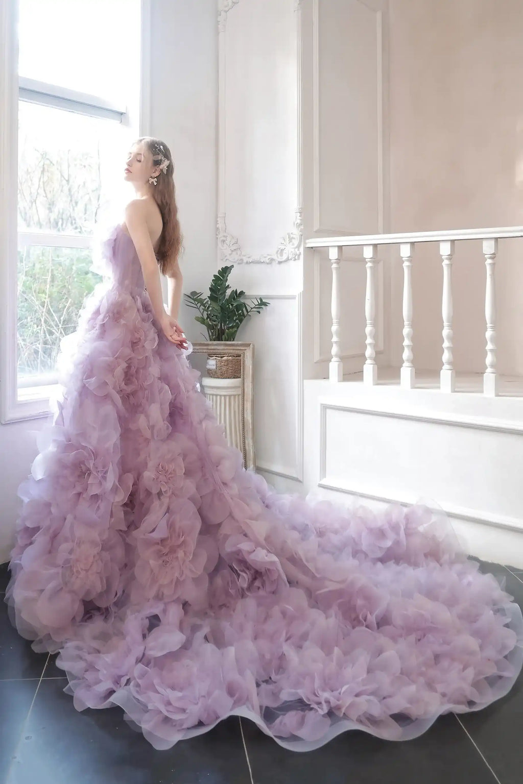 Mariée de dos montrant le haut du corset et le volume impressionnant de la robe de mariée lilas.