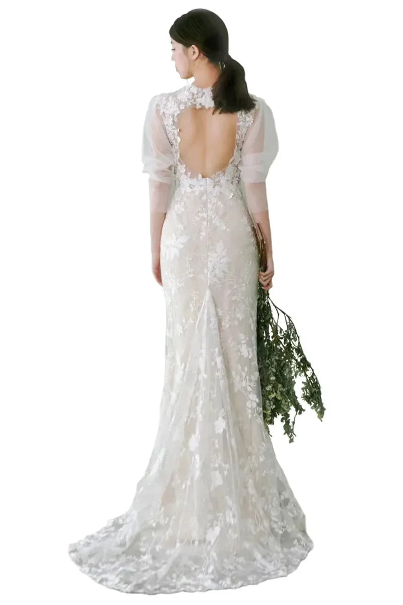 Vue du dos d’une belle femme en robe de mariée longue à manches bouffantes bohème chic