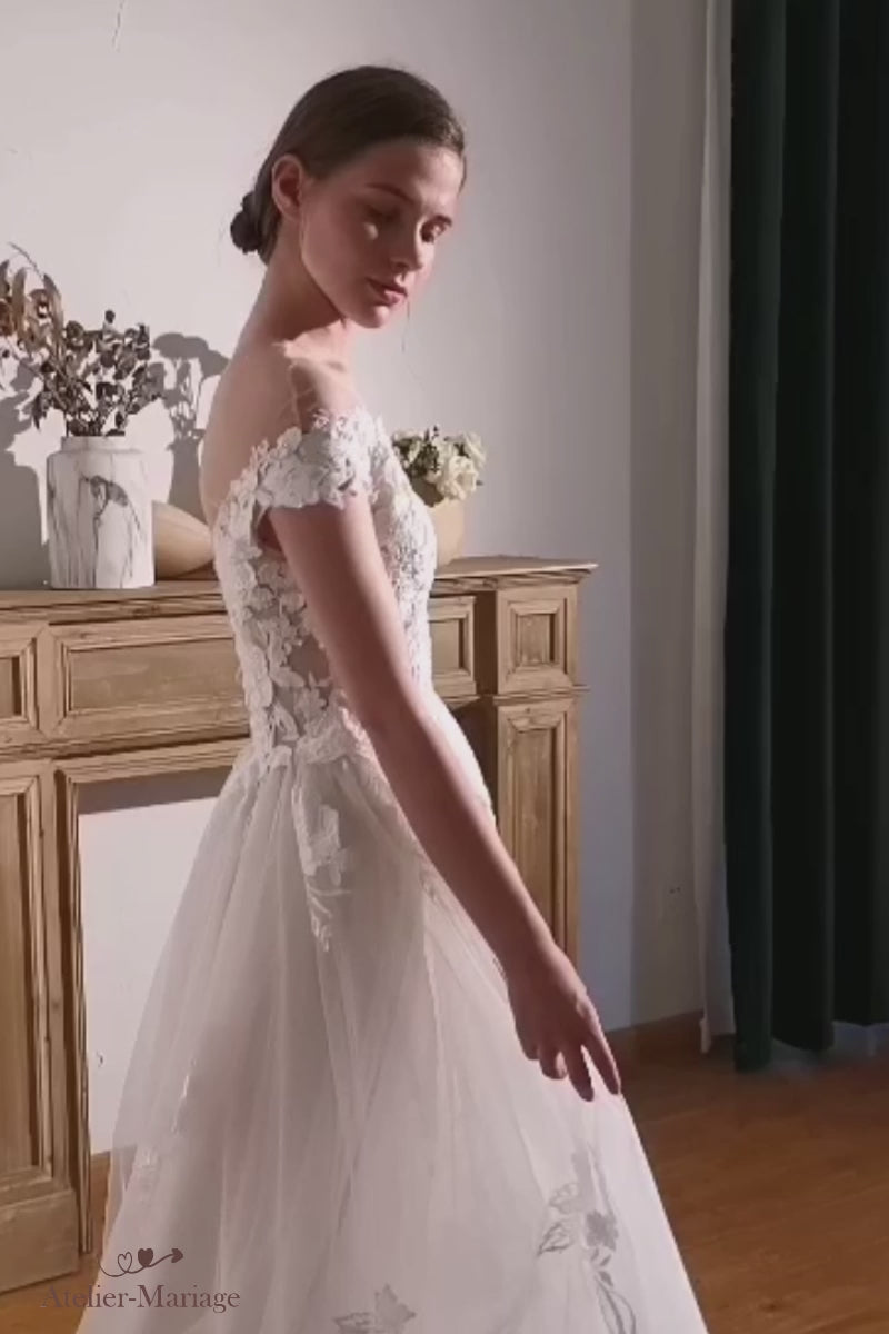 Vidéo d'essayage d'une robe de mariée bohème champêtre fluide, mettant en valeur son élégant col bateau en dentelle.