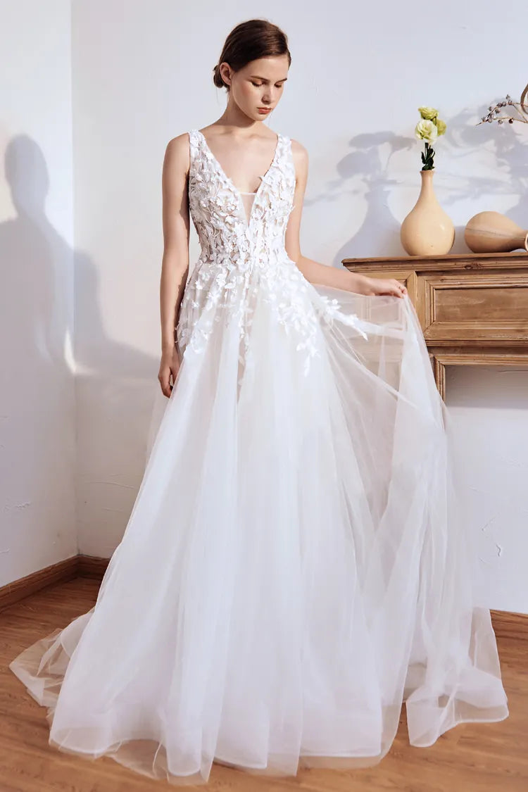 Mariée portant une robe au col V profond et bretelles fines.