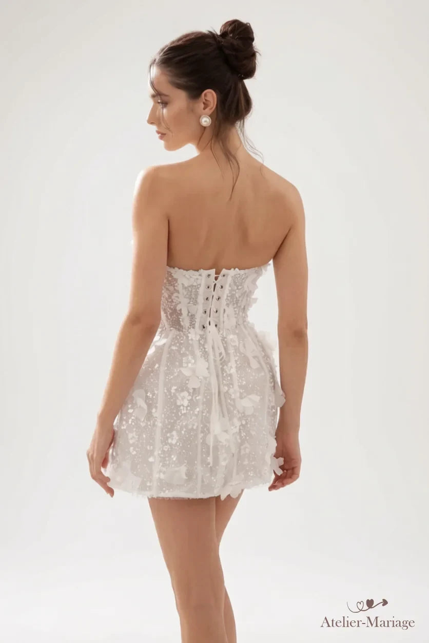 Dos de la robe de mariée courte perlée avec corset à lacer, portée par la mariée
