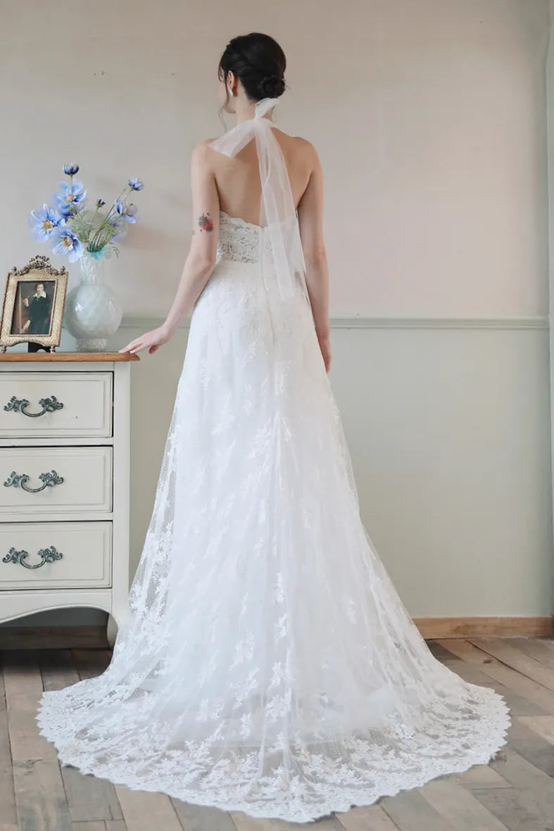 Robe de mariée dos nu spectaculaire avec longue traîne en dentelle florale et tulle.